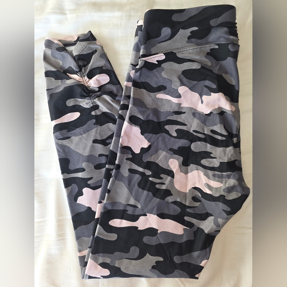 Calvin Klein Performance leggings in black, pink, and gray camouflage.